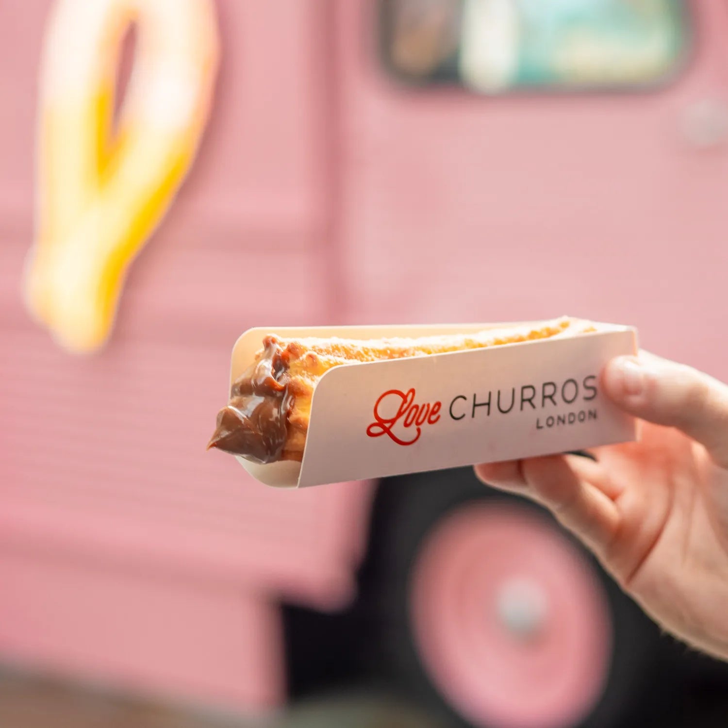 Chocolate-filled churros served in a Love Churros tray