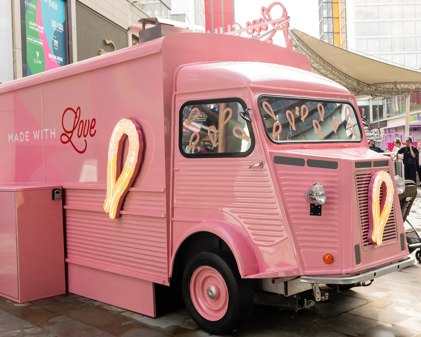 The pink Love Churros van with its golden churro emblem
